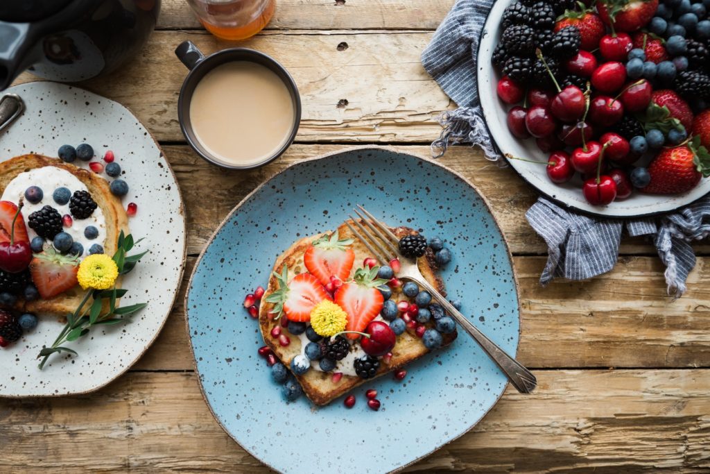plates with healthy breakfast: bread and fruit