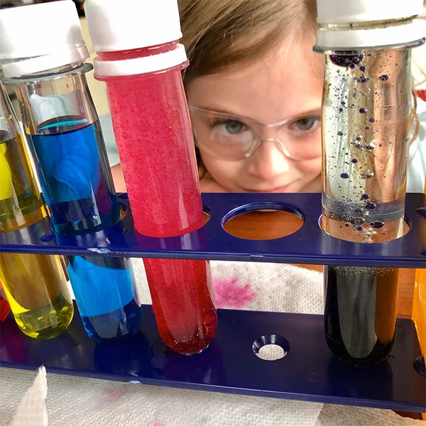 Child with safety goggles doing experiments